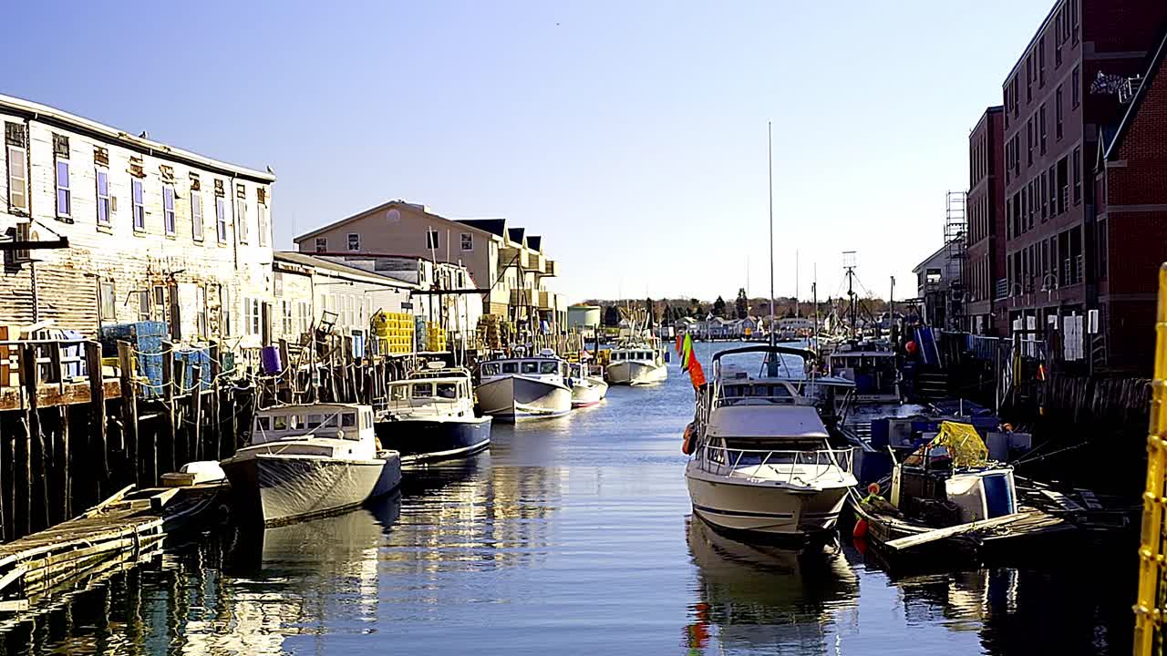 Portland, Maine harbor with working boats at dock and luxory condos