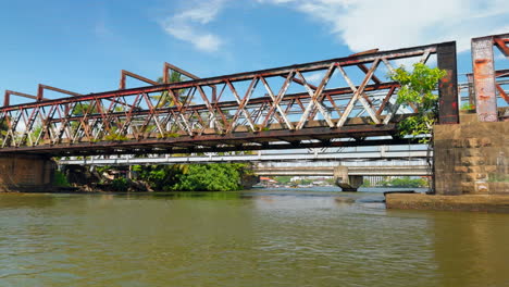 rusty old train bridge over a river