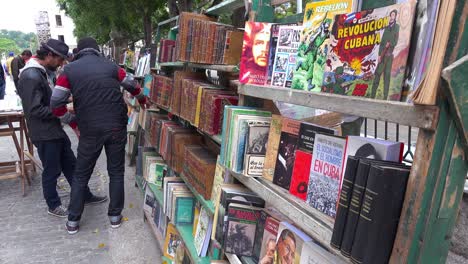 vendors on the streets of havana cuba sell old propaganda books and posters