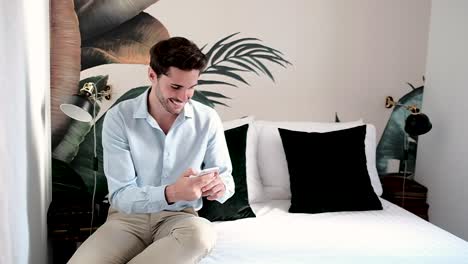 Cheerful-young-man-using-smartphone