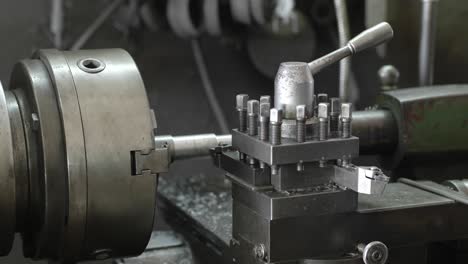 men's hands with a vernier caliper measuring the size of the details at work piece on lathe machine in the industrial factory. slow motion