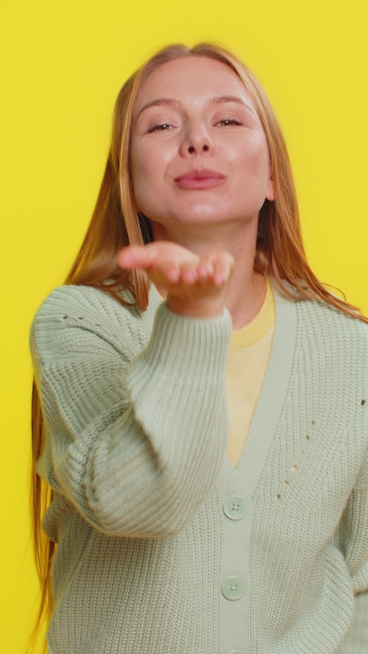 Smiling romantic happy woman sending lots of air kisses looking at camera love confession concept