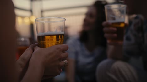 Close-up-of-beer-in-hand-of-young-man-at-the-party.