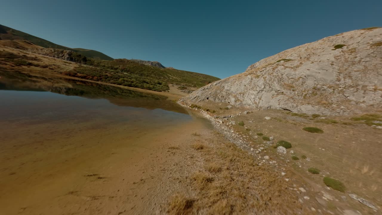 Wilderness alpine lake surrounded by ridges and meadows