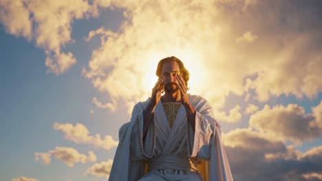 spiritual leader wearing pristine white attire, deeply immersed in prayer while gently covering eyes, standing against ethereal sunrise with soft luminous clouds spreading across expansive sky