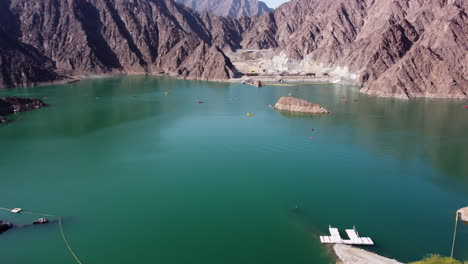 aerial circling shot of a dam in hatta, united arab emirates