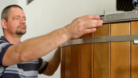 male worker examining a distillation tank 4k