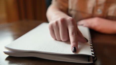 Close-Up-View-Of-Blind-Woman-Finger-Touching-The-Letters-Of-A-Braille-Book-1