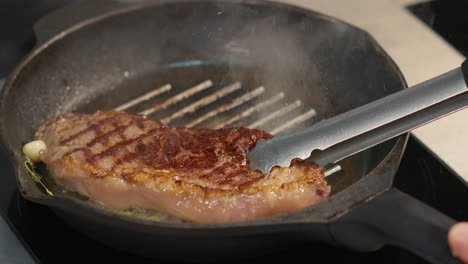cooking beefsteak with rosemary and garlic