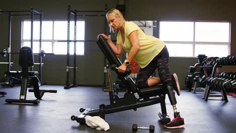 senior woman doing dumbbell row exercise 4k