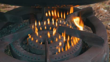 Rusty-gas-heater-burning-with-yellow-flames-under-a-black-cauldron