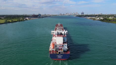 algoma bear vessel navigating the detroit river with detroit skyline in background, drone shot