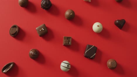 black and white chocolates on red background at valentine's day