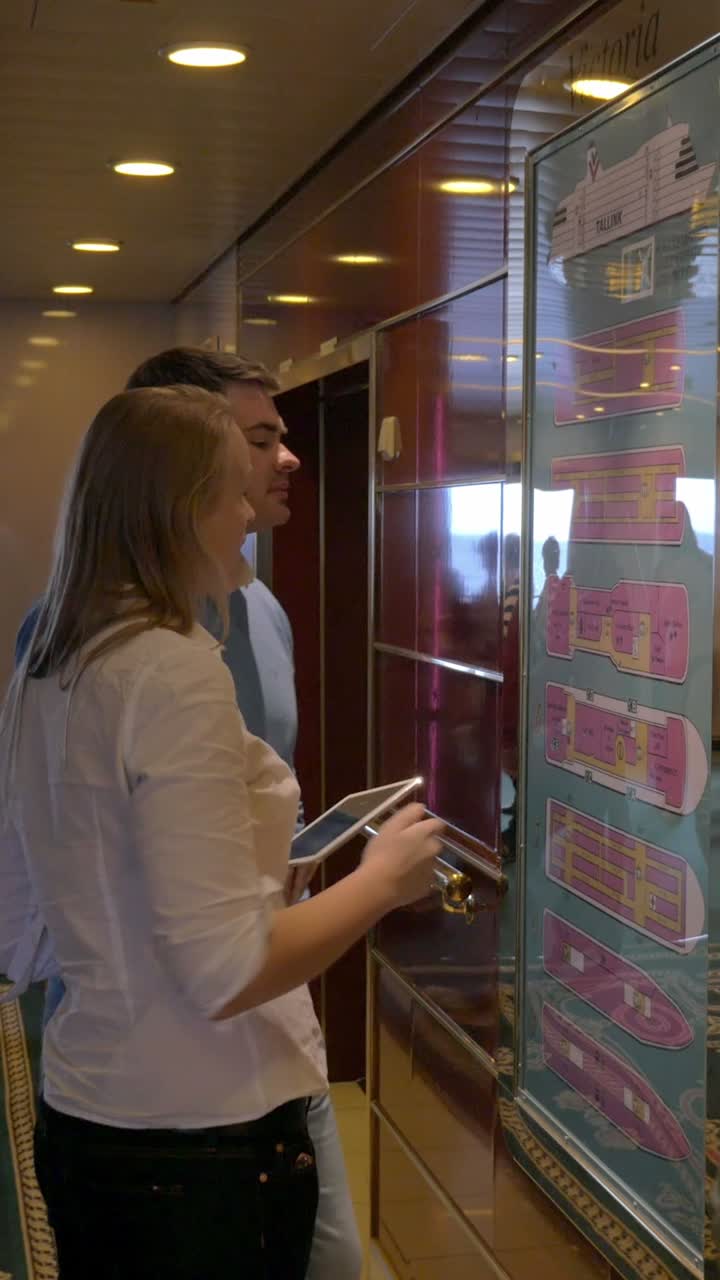 People looking at a ship's floor plan
