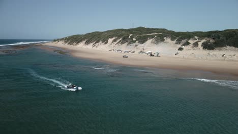 Aerial-orbiting-shot-of-a-tourism-expedition-vessel-sailing-off-Mozambique