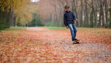 boy on a skateboard in an autumn park