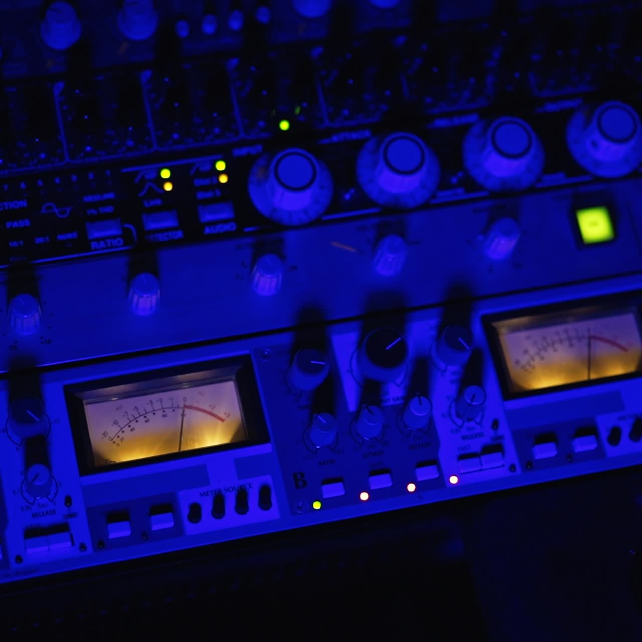 Equipment for professional music procession. Professional audio engineer's hand pressing the buttons on the stereo. Top view close up