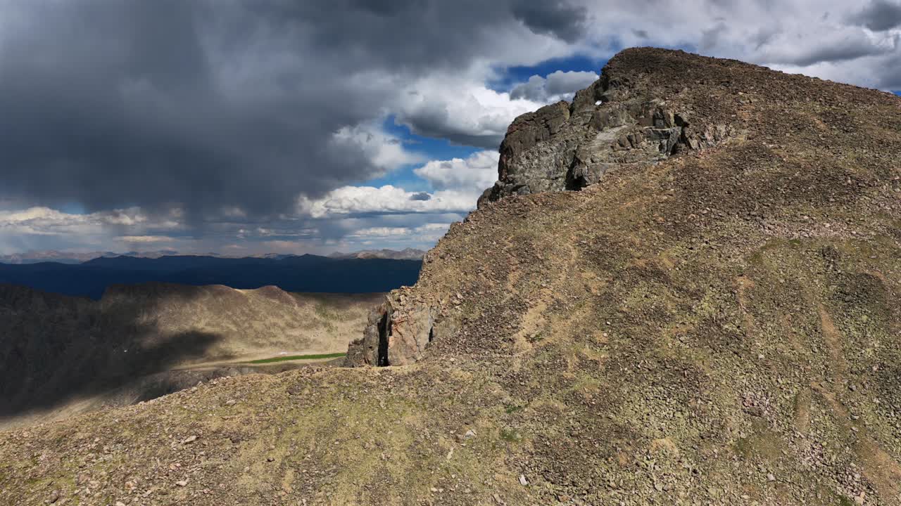 Mt Holy Cross 14er peak North Ridge Trail spring summer July afternoon sunny blue skies clouds Rocky Mountains Colorado aerial drone Sawatch Range top of summit high elevation forward pan up motion