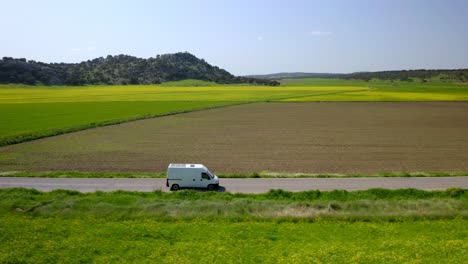 camper van driving near agricultural field