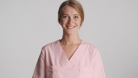 caucasian female doctor nodding on camera.