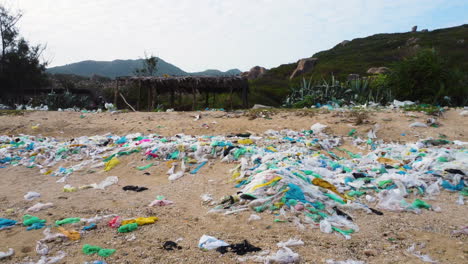 trucking shot of polluted beach with plastic,waste and trash in asia