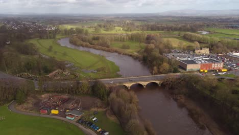 traffic passing on eden bridge over eden river with rickerby park in background - carlisle, england