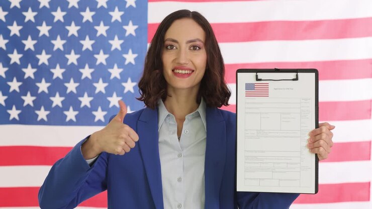 Woman holding USA visa application form with American flag background, showing thumbs up