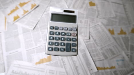 Pocket-calculator-falling-and-bouncing-on-papers