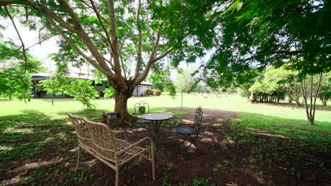 push in dolly to luxurious rural estate outdoor garden metal seating area with table bench and chairs