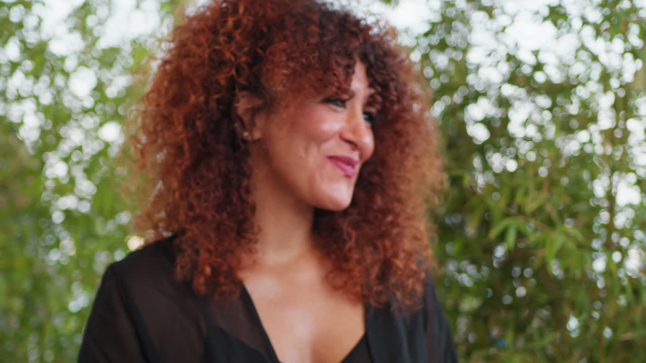 Woman Eating Fish With Fork And Smiling During Lunch At The Outdoor Restaurant