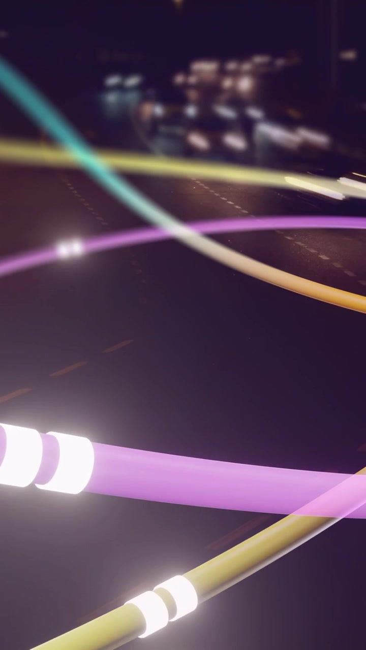 Video verticale: Nastri viola e ciano che attraversano la notte, attivati da un bagliore bokeh che si sposta per imitare le auto.
