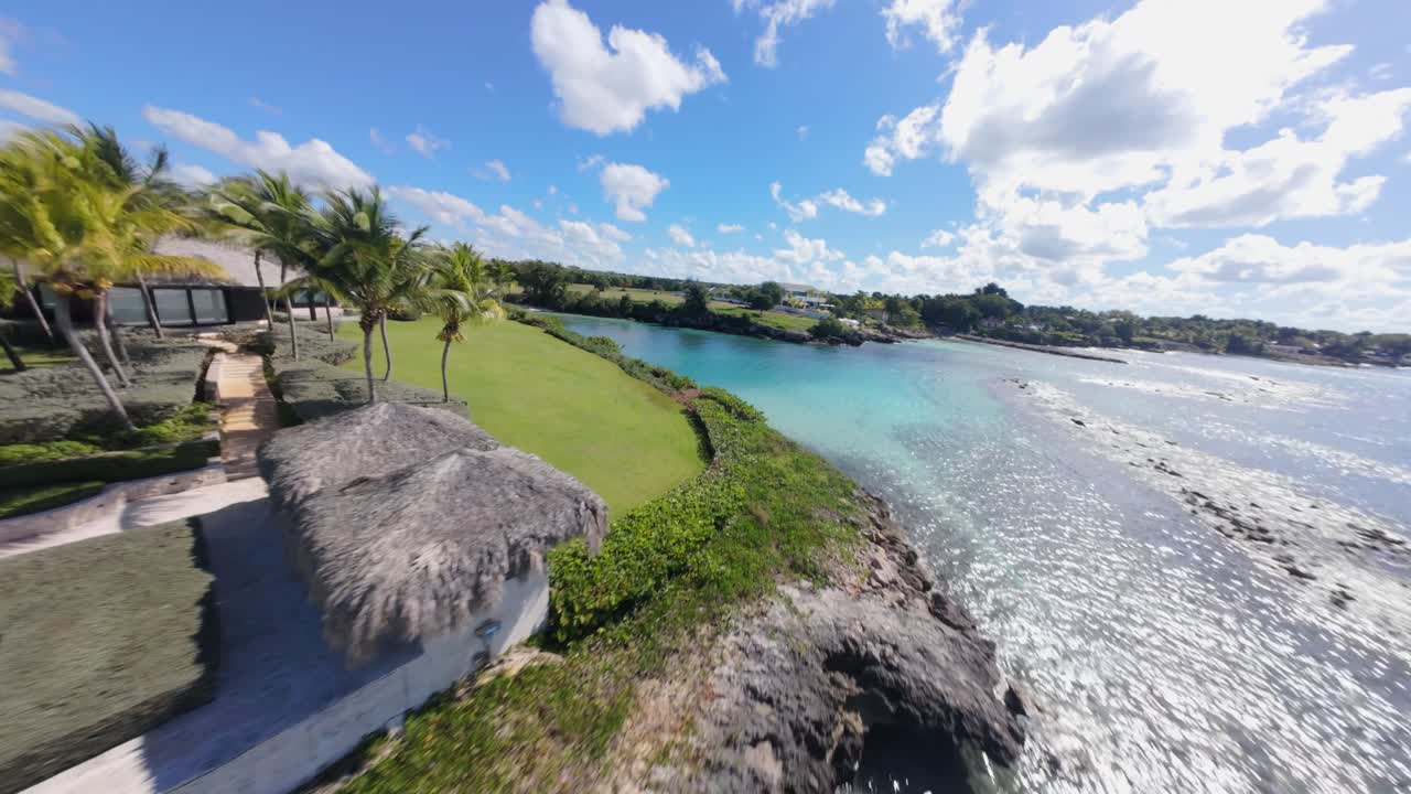Luxury resort Villa with swimming pool and Caribbean sea view in summer. DFPV speed flight over clear water of bay and sandy beach. Playa Caleton, La romana, Dominican Republic. Forward shot.