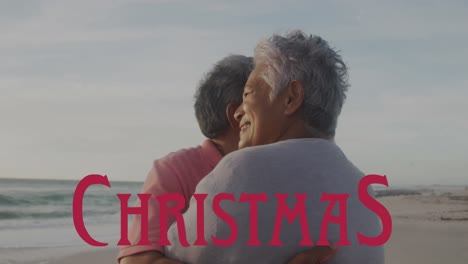 animation of christmas over happy senior hispanic couple on beach