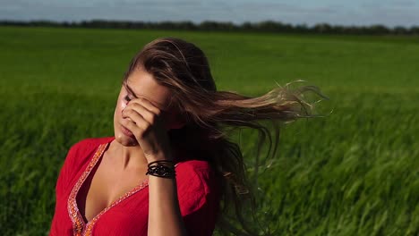 Woman in a Red Dress in a Field