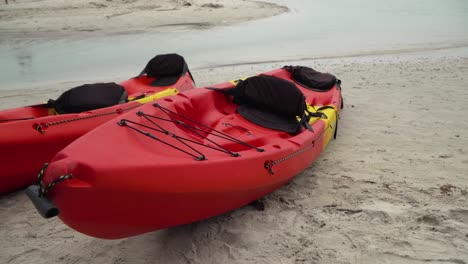 two-on-standby-kayak-on-sea-sands-of-thailand,-close-up-pan-left-shot