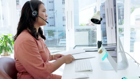 Call-center,-paperwork-and-woman-on-computer