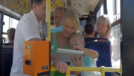 family entertaining with tablet pc in the bus