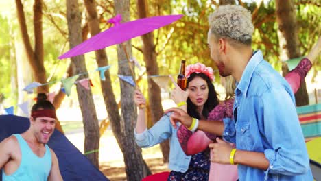 Friends-dancing-while-having-bottle-of-beer-in-park-4k