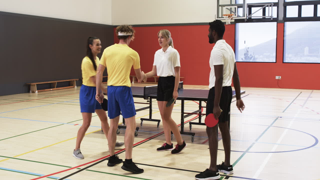 Playing table tennis, group of students shaking hands in school gym