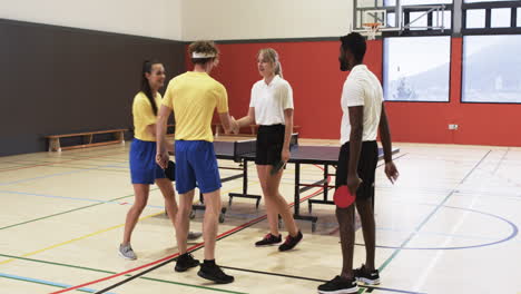 playing table tennis, group of students shaking hands in school gym
