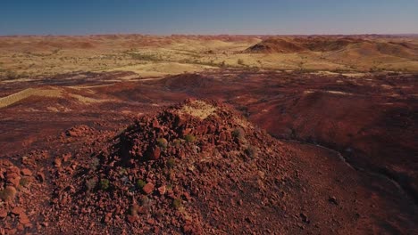 aerial drone orbiting around australian desert mountain after bushfire