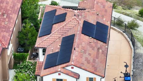 Aerial-view-rising-above-solar-panels-installed-on-suburban-residential-home-rooftop