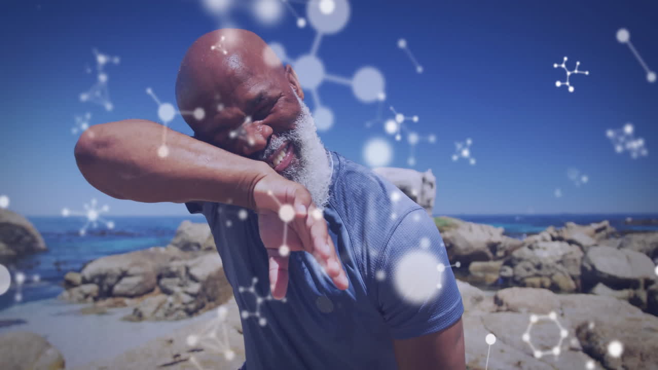 Smiling man at beach with molecular structure animation overlay, enjoying sun