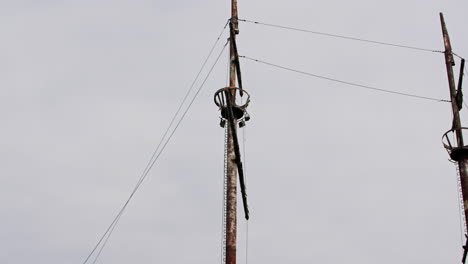 Mast-of-rusty-red-shipwreck-stuck-in-shallow-green-water