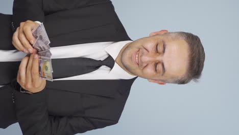 Vertical-video-of-Rich-businessman-counting-money.