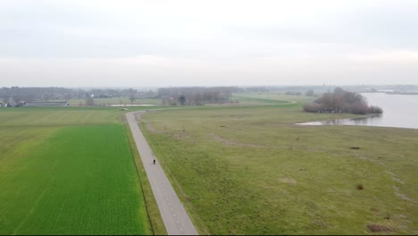 very high drone shot of motorcyclist driving on a moped