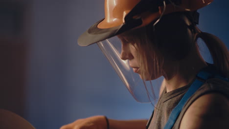 woman in safety gear working in a workshop