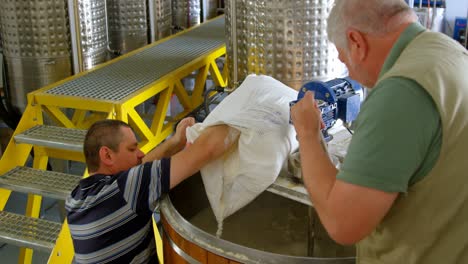 male workers preparing gin in distillery 4k