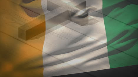 casting shadow over irish flag, wooden cross in soft lighting creating animation