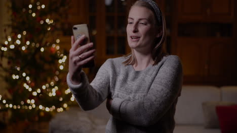 positive woman video chatting christmas smartphone 5